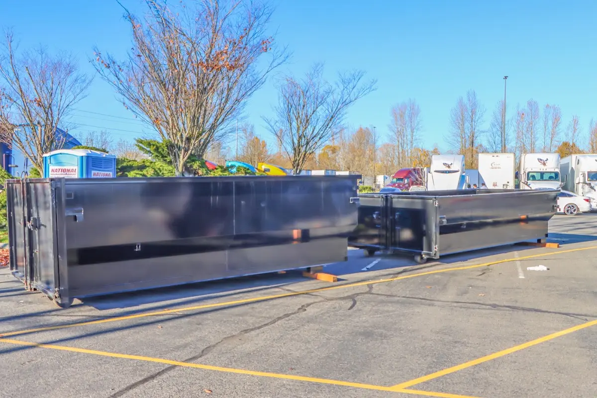 Professional dumpster rental service with roll-off container on residential driveway in Marble Falls